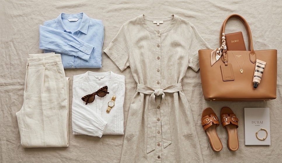 elegant Dubai outfit essentials arranged to show breathable polished travel fashion for women