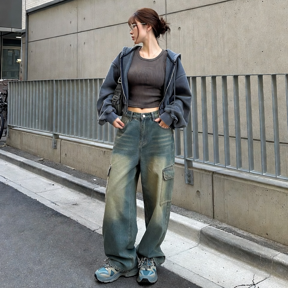 Woman wearing a slouchy Gen Z streetwear outfit with baggy jeans, fitted top, and casual jacket